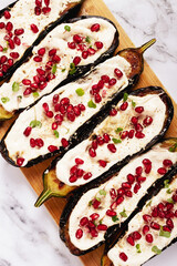 fried eggplant with sauce, decorated with microgreens and pomegranate seeds, eggplant appetizer, top view, homemade, no people,