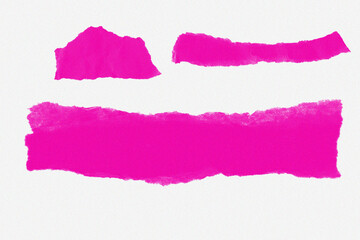 Several bright pink torn paper strips on textured white background isolated on white background