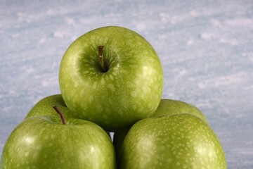Image of five granny smith apples.