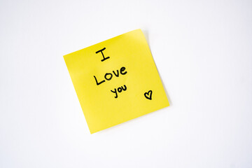 Sticky note with ‘I love you’ written on it and a white background