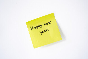 Happy New Year written on yellow paper with a red background