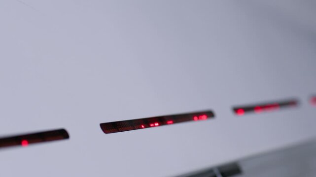 Red LEDs on the front panel of grain fractionation and sorting equipment are working with wheat on a flour mill. A machine for processing dry grain provides seed separation