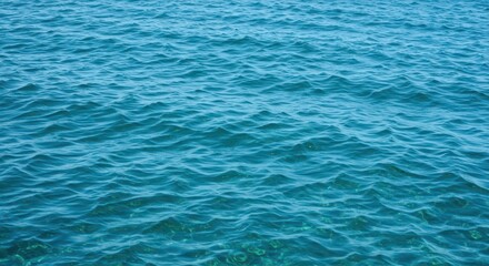 Obraz premium Sparkling, clear blue ocean water surface texture showing subtle wave motion and reflecting sunlight, emphasizing the vast, deep, salty nature of the sea, bright, ocean, saltwater