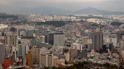 Seoul cityscape filling scene with residential and commercial buildings extending to mountains