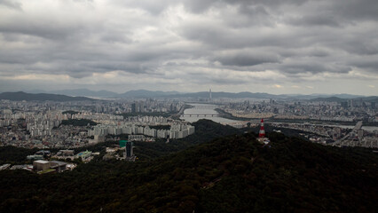 Seoul cityscape and Han River under a cloudy sky, showing urban development and nature