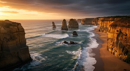 Twelve Apostles limestone cliffs along Great Ocean Road at sunset with ocean waves crashing