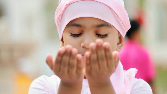 Smiling child in pink turban, celebrating Guru Nanak Jayanti, cultural tradition, Sikh festival, joyful expression, religious attire, festive atmosphere, spiritual celebration