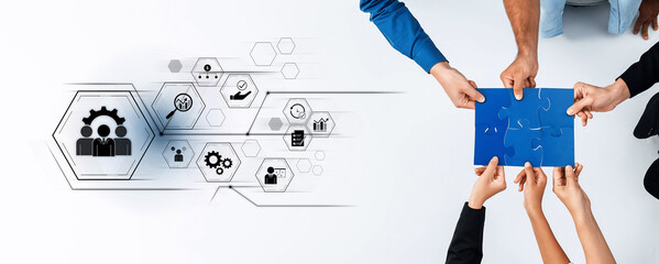 Hands unite in a collaborative effort, piecing together a puzzle while surrounded by icons...