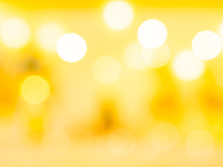 Warm golden yellow abstract background with soft bokeh lights and glowing circles