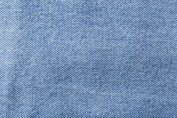 The denim is light blue. Denim background.