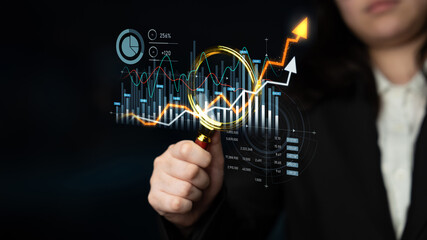 A business professional uses a magnifying glass to analyze financial data, showcasing growth trends and stock market graphics against an abstract background. Scalp
