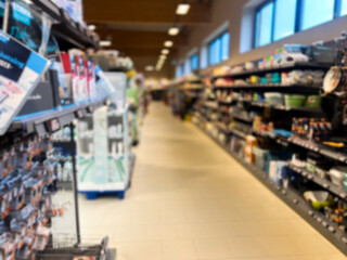 Blurred supermarket grocery store aisle and shelves 