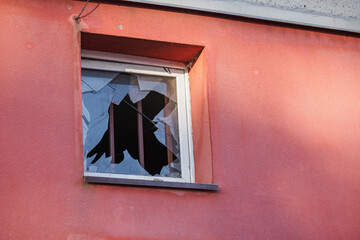 Square broken window with metal bars.
