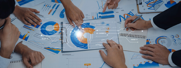 Engaged team collaborates on business planning, utilizing charts and visual data to drive effective...