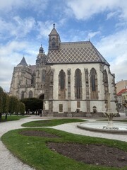 Fototapeta premium St Michael Chapel in Košice Slovakia main square with its characteristic patterned roof and St Elisabeth Cathedral behind it