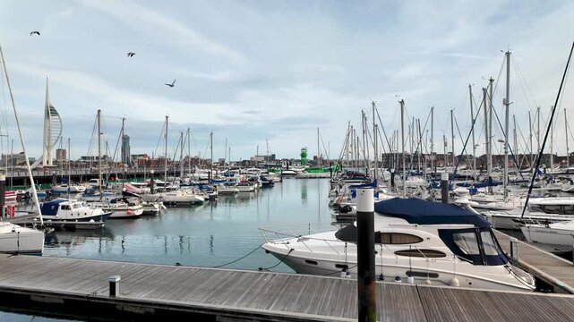 Pleasure boats and yachts moored in Gosport Marina. Tracking shot