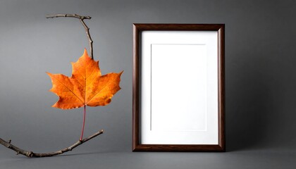 Autumnal Still Life - Maple Leaf and Empty Frame on Gray.
