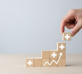Growth and progress concept with wooden blocks stacked upward and glowing plus signs. Business improvement, success, positive mindset, teamwork, motivation, development, and financial achievement 