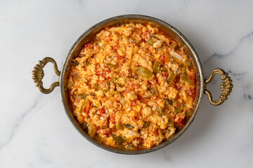 Turkish traditional menemen dish made with eggs, peppers and tomatoes