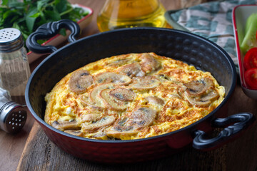 Frittata is a type of Italian omelet. Mushroom omelette made in a cast iron pan.