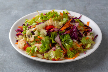 Turkish style lettuce salad. Diet salad with lettuce, red cabbage, tomatoes, and carrots.
