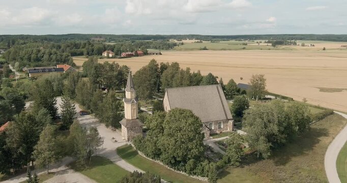 Aerial view of Pertteli church is a medieval grey granite church dedicated to Bartholomew the Apostle in summer, Pertteli, Finland.