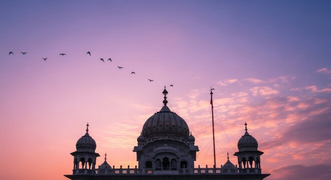 Majestic Gurdwara against colorful dawn sky for Guru Nanak Jayanti celebration. Architecture of a Gurdwara, illuminated by sunlight and silhouetted against a backdrop of pink and purple hues,