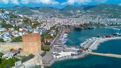 Naklejka premium Alanya - Turkey, October 26, 2025, An aerial view of the bay Alanya in Antalya Turkey. Sea and city with an open sky. Kizil Kule - Alanya