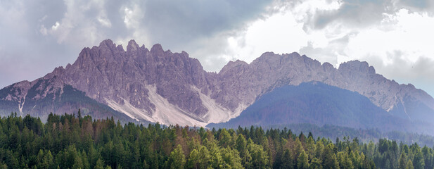 Dramatic Dolomites Ridge with Forest and Clouds, South Tyrol