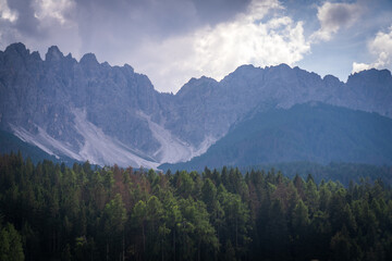 Dramatic Dolomites Ridge with Forest and Clouds, South Tyrol