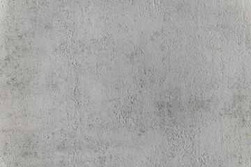Pale white plaster wall showing fine texture and slight weathering. Neutral minimalist surface ideal for backgrounds, architectural visuals, or modern design projects