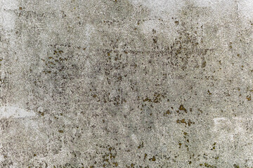 Rough white wall with discoloration, dirt, and natural weathering. Ideal as background texture or design element for creative and architectural projects