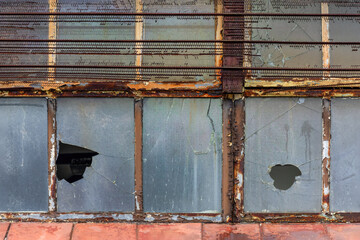 lose-Up of Broken Glass and Rusted Frame on Abandoned Building