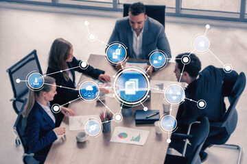 A group of business professionals engages in discussion around a conference table, enhanced by a digital interface showing analytics and data connections. Tessel