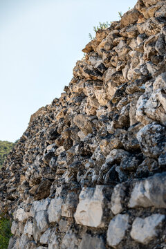 Old drywall with numerous stones stacked to form beautiful, rough wall, supporting the olive plantation on the slope, at the village of Valun, Croatia on the wonderful Cres island