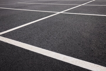 Reflective wet asphalt grid, Urban nighttime scene with textured asphalt and reflections, Cityscape at night showing glossy wet road surfaces and geometric line