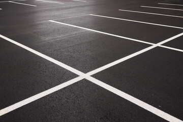 Reflective wet asphalt grid, Urban nighttime scene with textured asphalt and reflections, Cityscape at night showing glossy wet road surfaces and geometric line