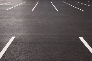 Reflective wet asphalt grid, Urban nighttime scene with textured asphalt and reflections, Cityscape at night showing glossy wet road surfaces and geometric line