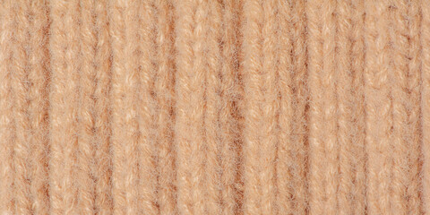 Beige knitted texture macro photo as background.