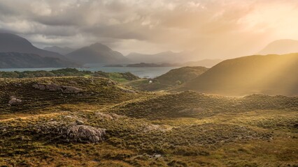 Looking towards Loch Shieldaig as the sunshine beam crosses the Scottish land in Ardheslaig, Strathcarron, UK