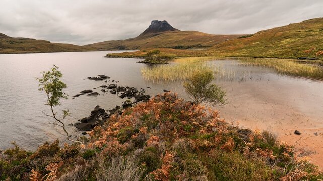 A view of Stac Pollaidh from Loch Lurgainn during a Scottish autumn in Ullapool, UK