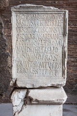 Antique marble plaque with Latin writing in the Colosseum in Rome - Italy