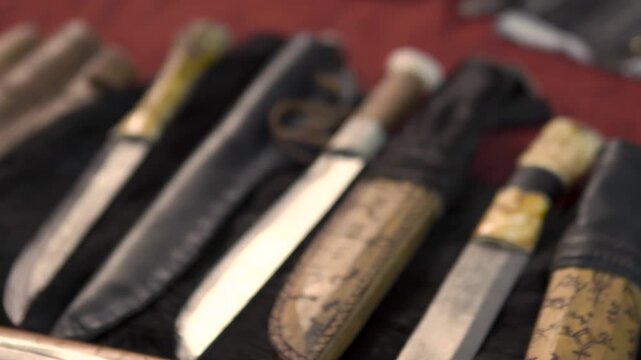 A highly detailed view of medieval ornaments. Featuring antique style, knives, a helmet, Norse symbols, accessories, irons, and a scabbard. Medieval knight's clothing and accessories.