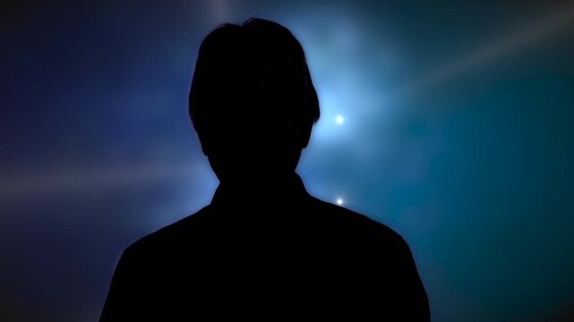 Medium shot man in silhouette taking to camera