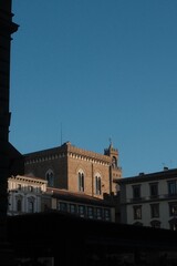 Obraz premium Florence building facade bathed in golden hour light with blue sky with analog film effect