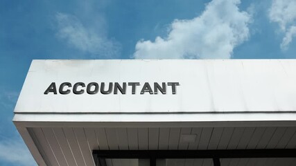 Professional Accountant word sign prominently displayed on an office building against a clear blue sky. Perfect for finance, business services, taxation, and professional expertise themes