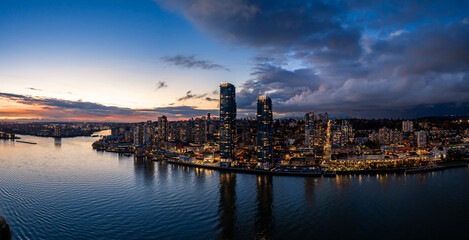 Fototapeta premium Breathtaking Vancouver Skyline Over Calm Water At Sunset With City Lights