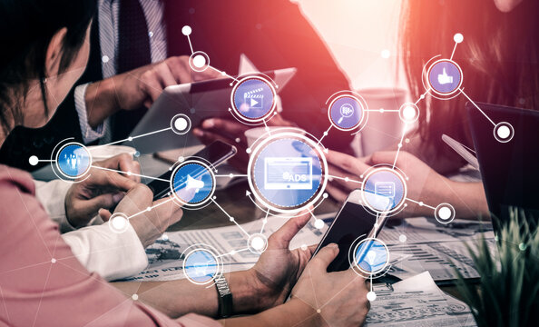 A dynamic scene of business professionals using smartphones and tablets in a meeting. Conceptual icons overlay the image, illustrating digital marketing and connectivity. Tessel