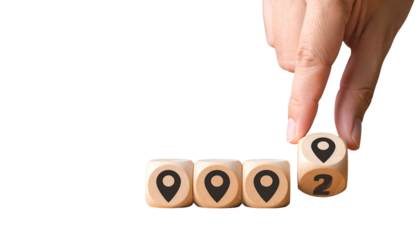 Hand placing dice with location markers; four dice visible on black