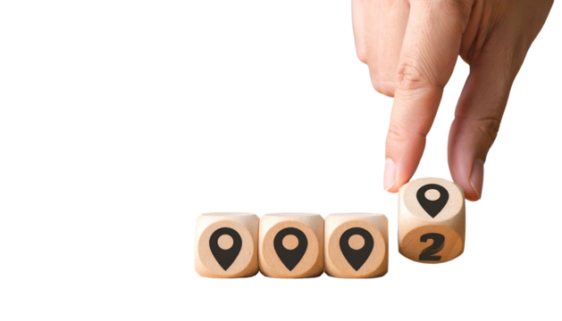 Hand placing dice with location markers; four dice visible on black